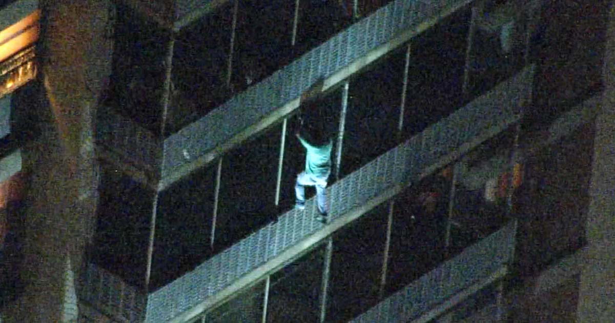 man-climbs-building-save-mom