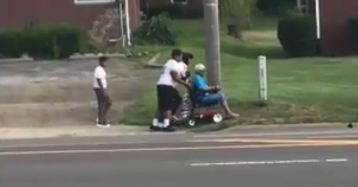 Middle-School-Football-Players-Helps-Wheelchair-bound-Elderly-Woman-main