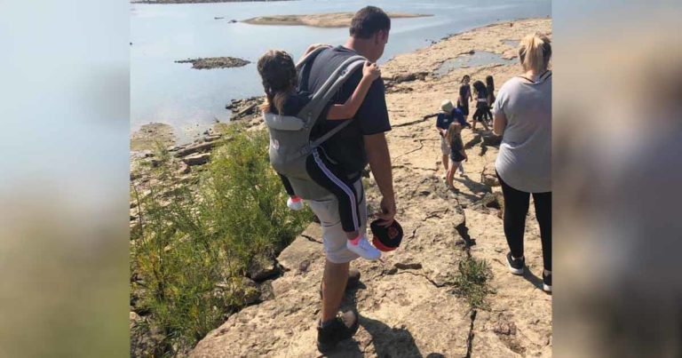 teacher carries student with spina bifida