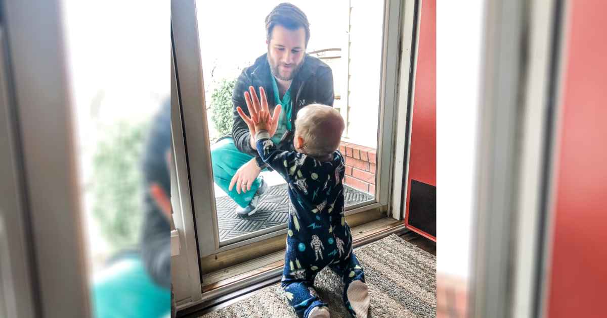 doctor-sees-son-through-glass-door