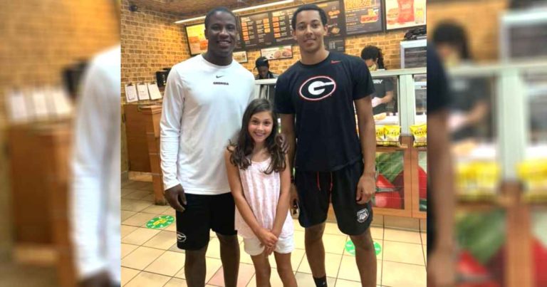 football-player-helps-kid-subway