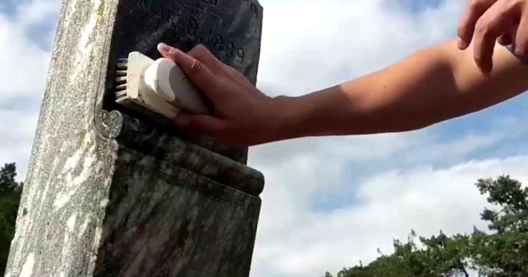man-cleans-gravestones