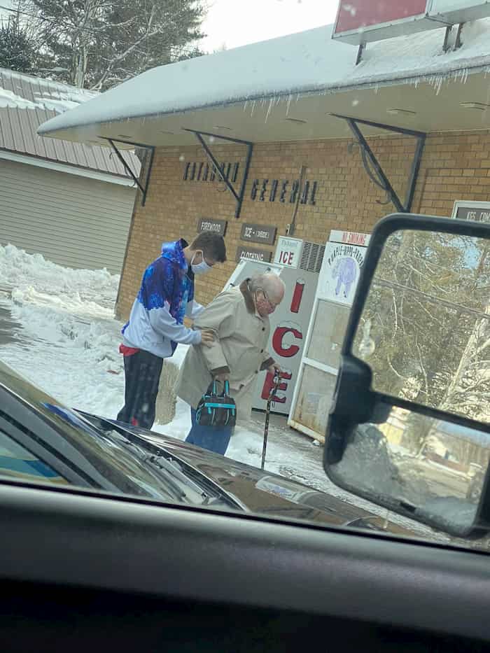 man-helps-elderly-woman-cross-street