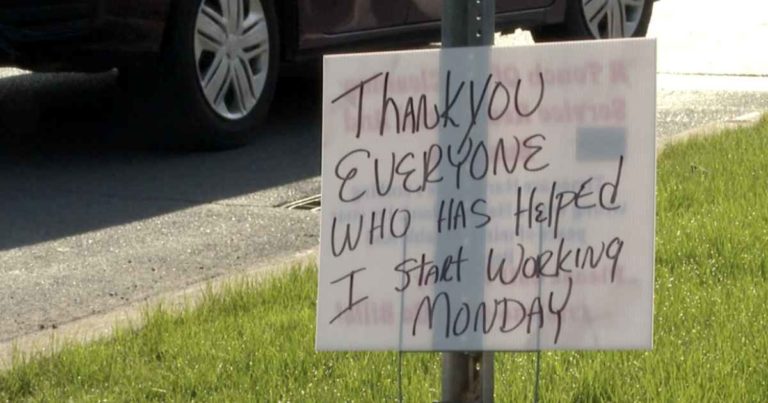 man-thanks-community-sign