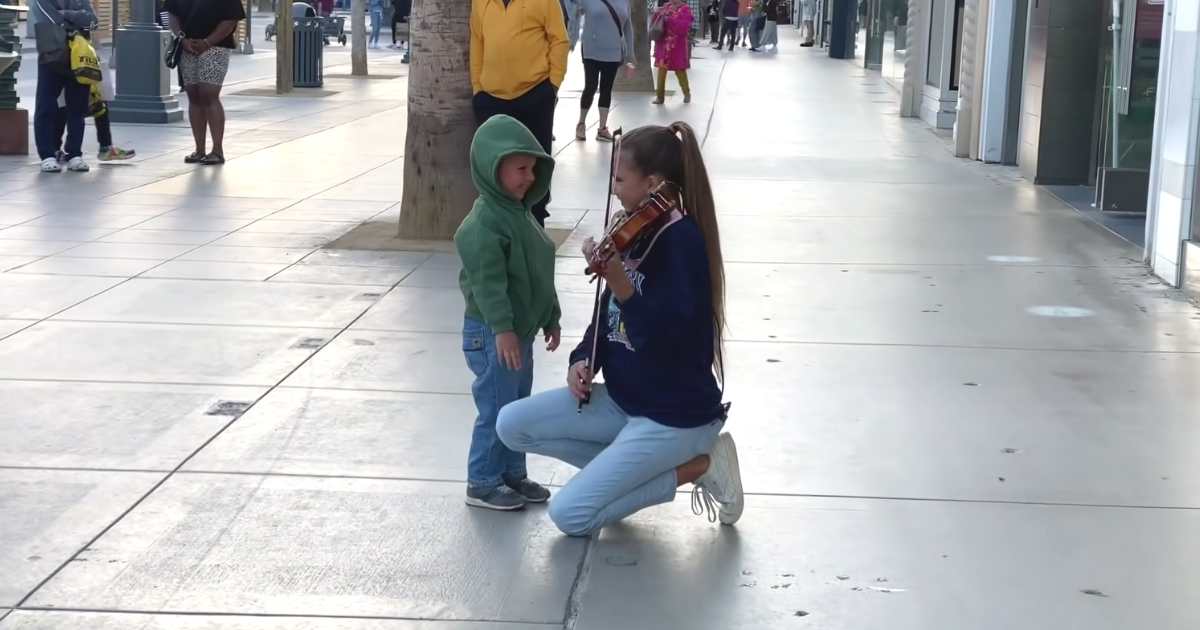 boy hugs violinist Karolina Protsenko
