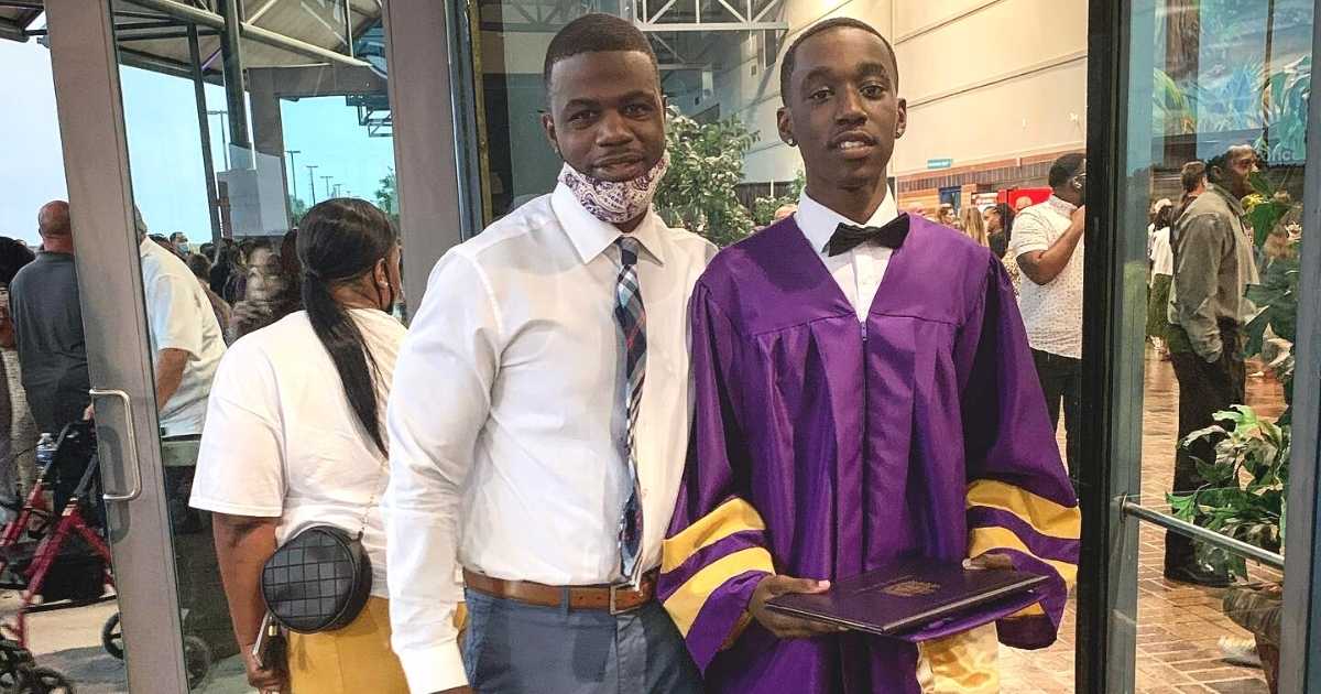 teacher gives shoes to graduate