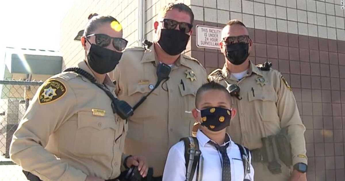 cops escort boy to school