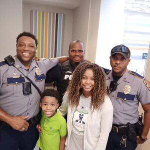 girl hugs police officers rosalyn baldwin