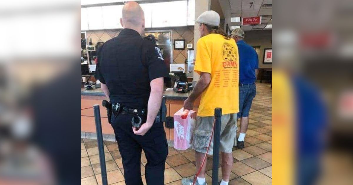 police officer feeds homeless man
