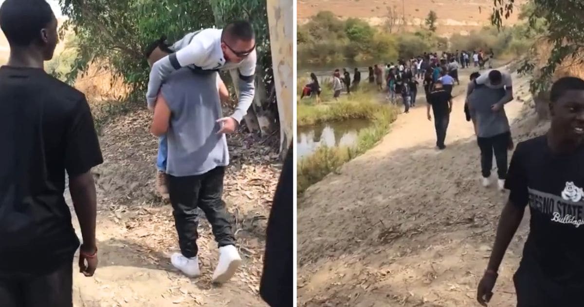 students carry teacher with wheelchair