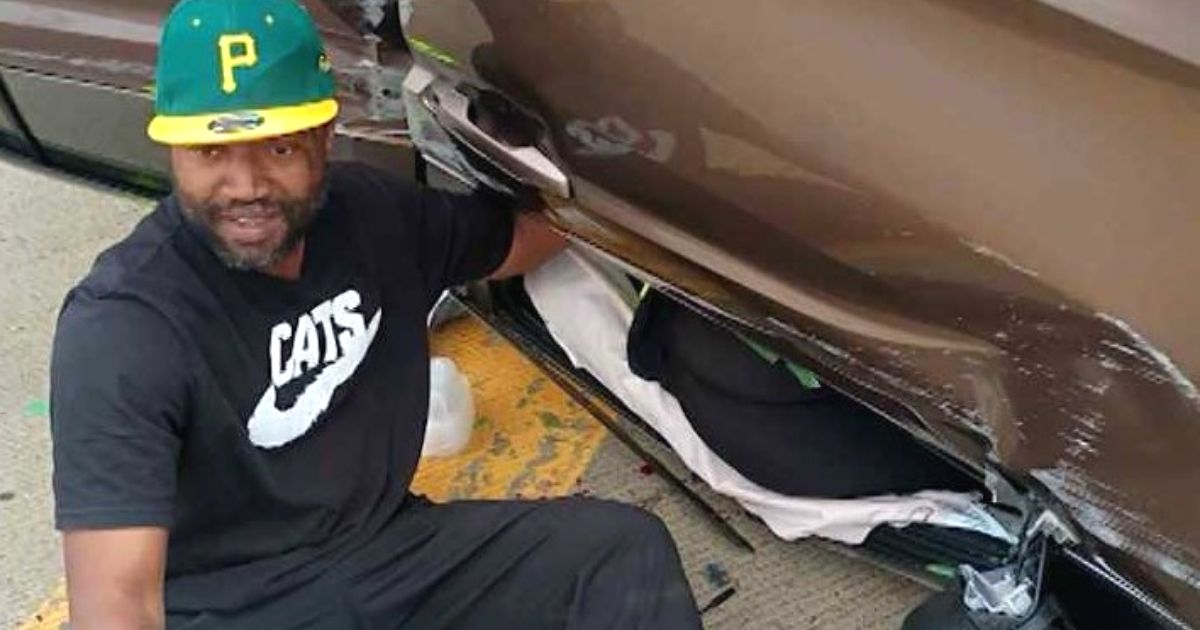 man comforting crash victim