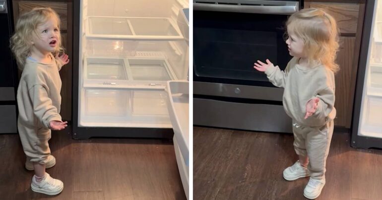 little girl opening empty refrigerator