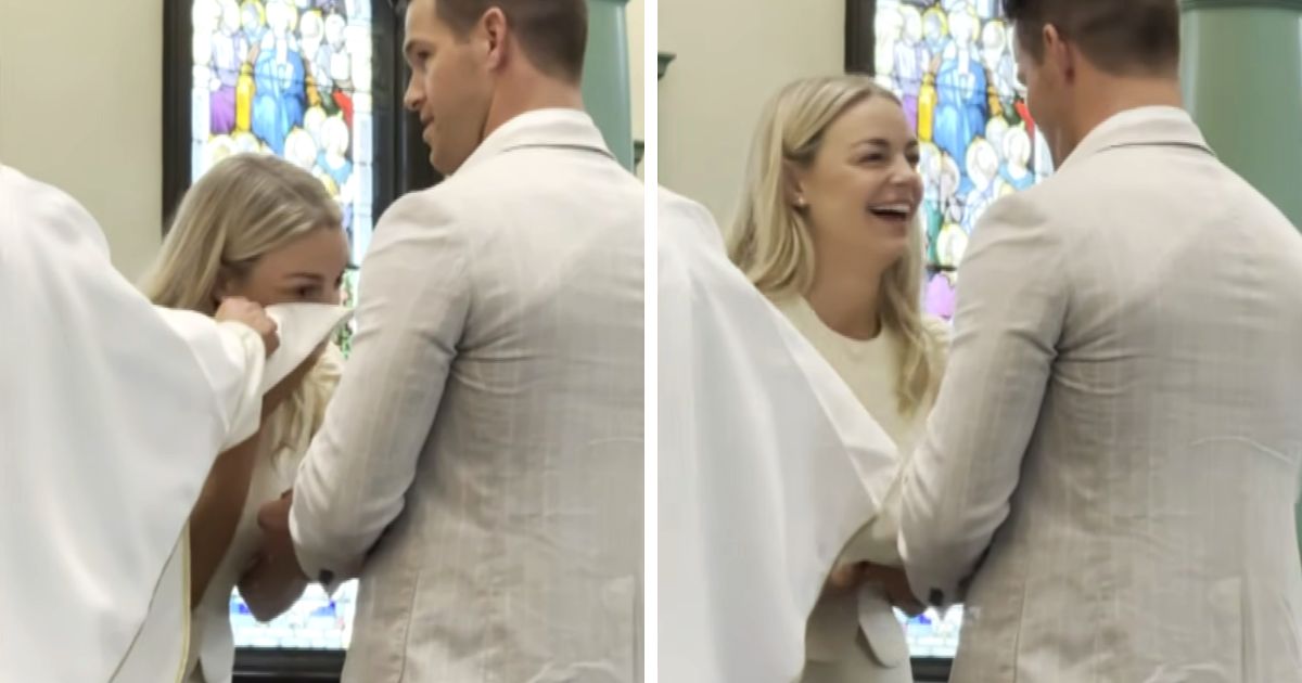 bride wipes tears on priest robe